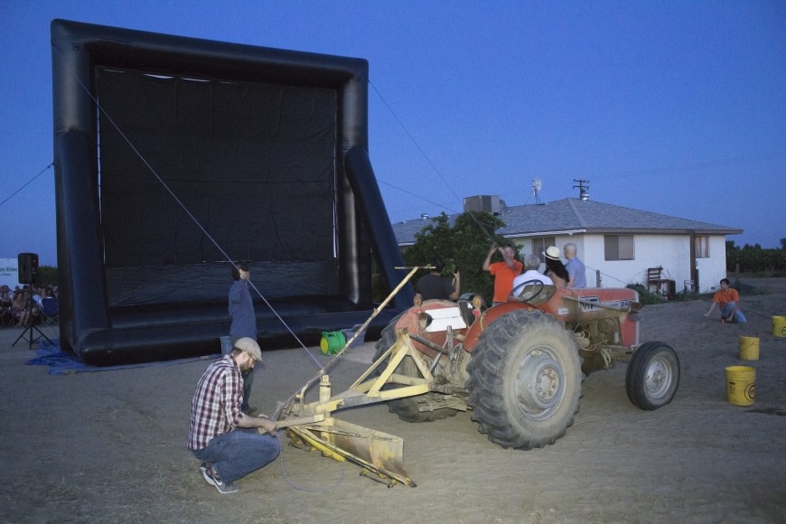 Mas comes to the rescue and fires up his tractor, tethering the screen to the tractor and re-inflating it. Photo by Diana Li