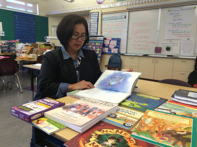 Bernadette A. Ison teaches second grade in the Filipino FLES program at Bessie Carmichael Elementary School in San Francisco. Here, she shows some of the Filipino curriculum.