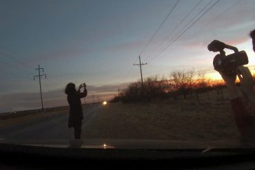 An image of two young women of color holding film cameras silhouetted by the light of the sunset. The filmmaker is Nadia Shiihab, director of Jaddoland.