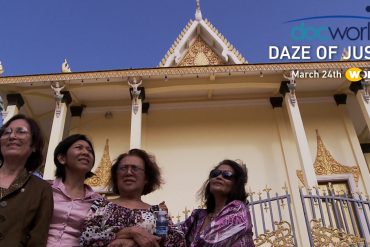 An image of four Cambodian American women in front of a building in Cambodian. They look determined. They are here at the UN Khmer Rouge Tribunals hoping to find peace and justice.