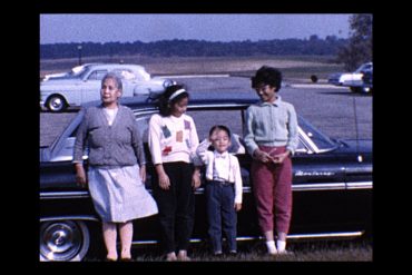An image of an Asian American family that is a still from a family home movie.