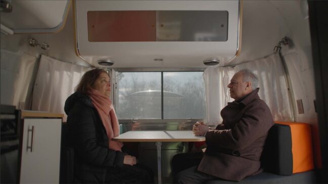 man and woman speaking to each other