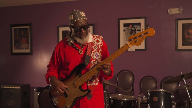 guy in red playing guitar